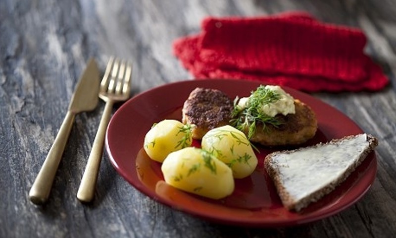 Frikadeller og kartofler på en rød tallerken Frikadeller og kartofler på en rød tallerken