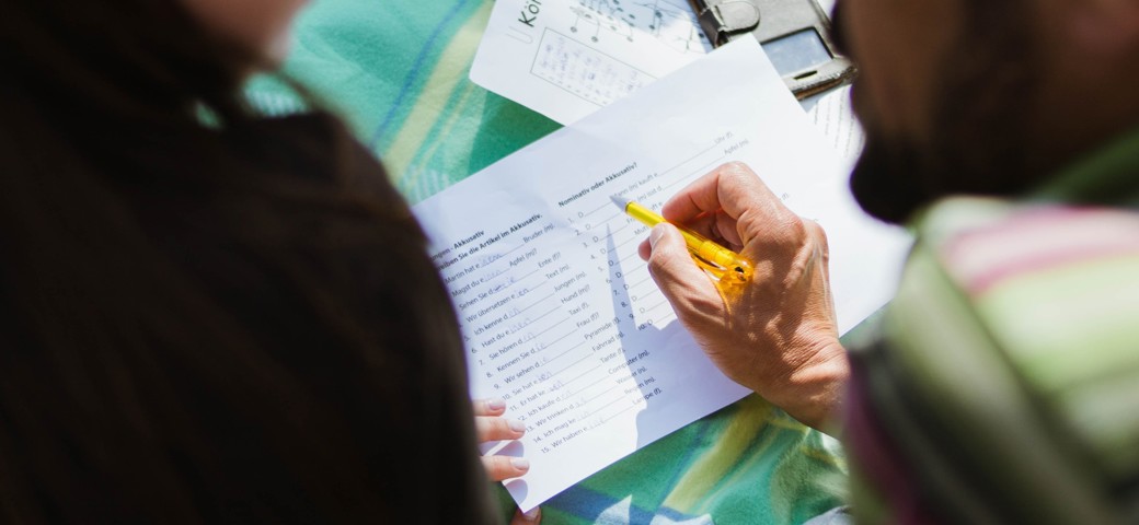 People talking and writing notes