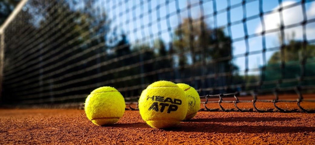Tennis court with yellow tennisballs