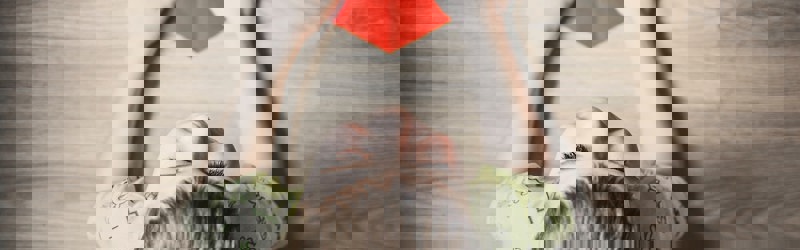 Child with red paper heart